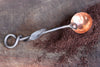 a blacksmith hand forged copper and steel coffee scoop with a leaf handle by Wicks Forge
