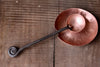 a blacksmith hand forged copper spoon rest under a coffee scoop by Wicks Forge