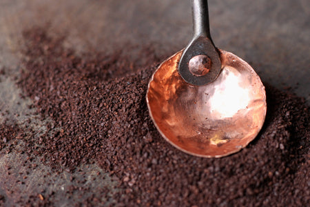 the copper dish of a copper and steel coffee scoop by Wicks Forge