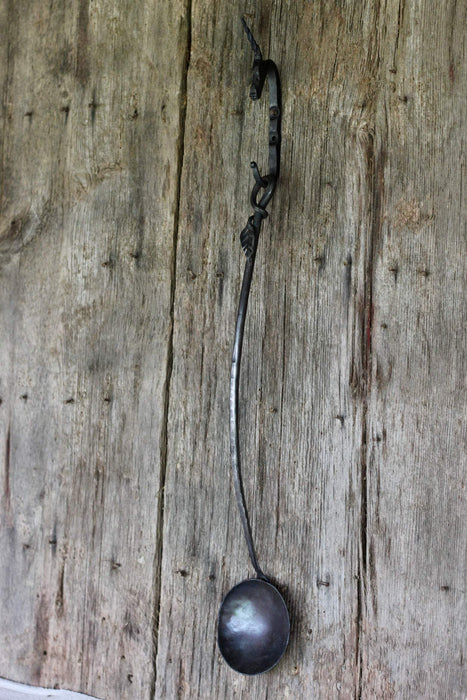 a blacksmith hand forged egg spoon with a leaf handle by Wicks Forge