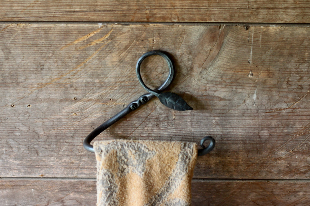 a blacksmith hand forged towel rack with a leaf design by Wicks Forge