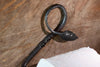 a blacksmith hand forged toilet paper holder with a leaf detail by Wicks Forge