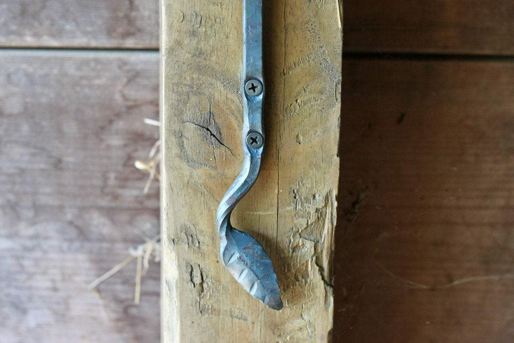 a blacksmith hand forged plant hanger with a leaf design by Wicks Forge