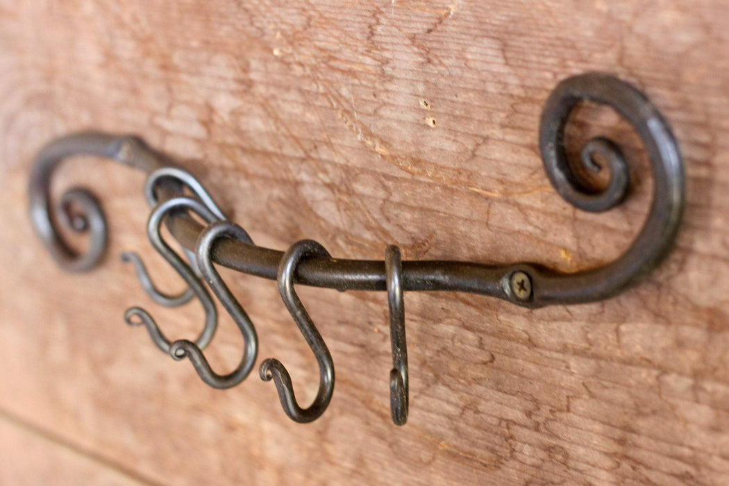 a blacksmith hand forged pot and pan holder with a scrolled design by Wicks Forge