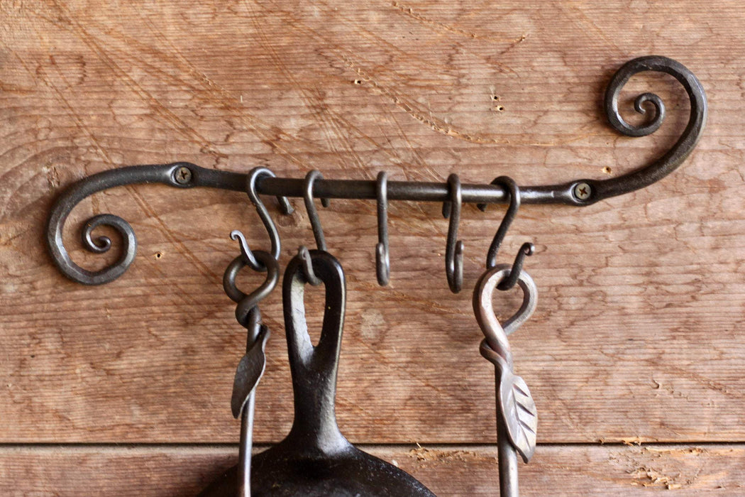 a blacksmith hand forged pot and pan holder with a scrolled design by Wicks Forge