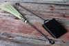 fire broom and shovel  set on a wooden surface by wicks forge 