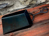 shovel on a wooden background and stone wall in the background 