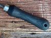 a black wooden handle on a wooden surface by wicks forge 