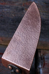 a brass cake slicer with rustic wooden background by wicks forge 