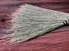 bristles of a broom on a wooden table 