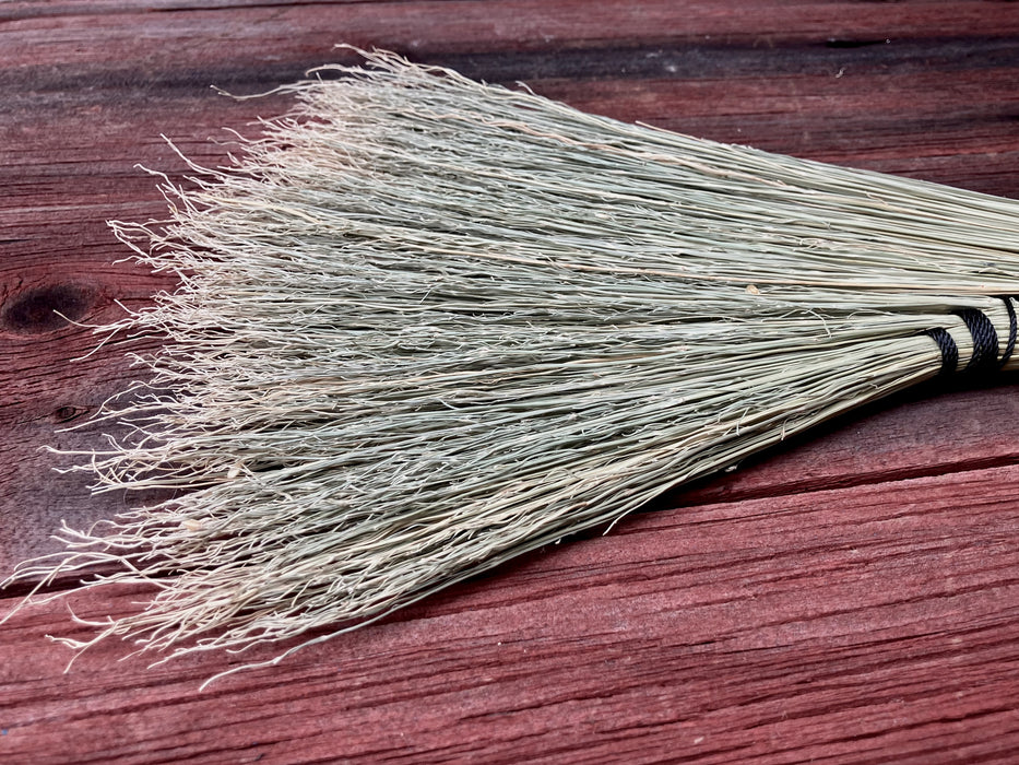 bristles of a broom on a wooden table 
