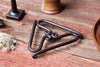 trivet on a wood surface with accessories around 