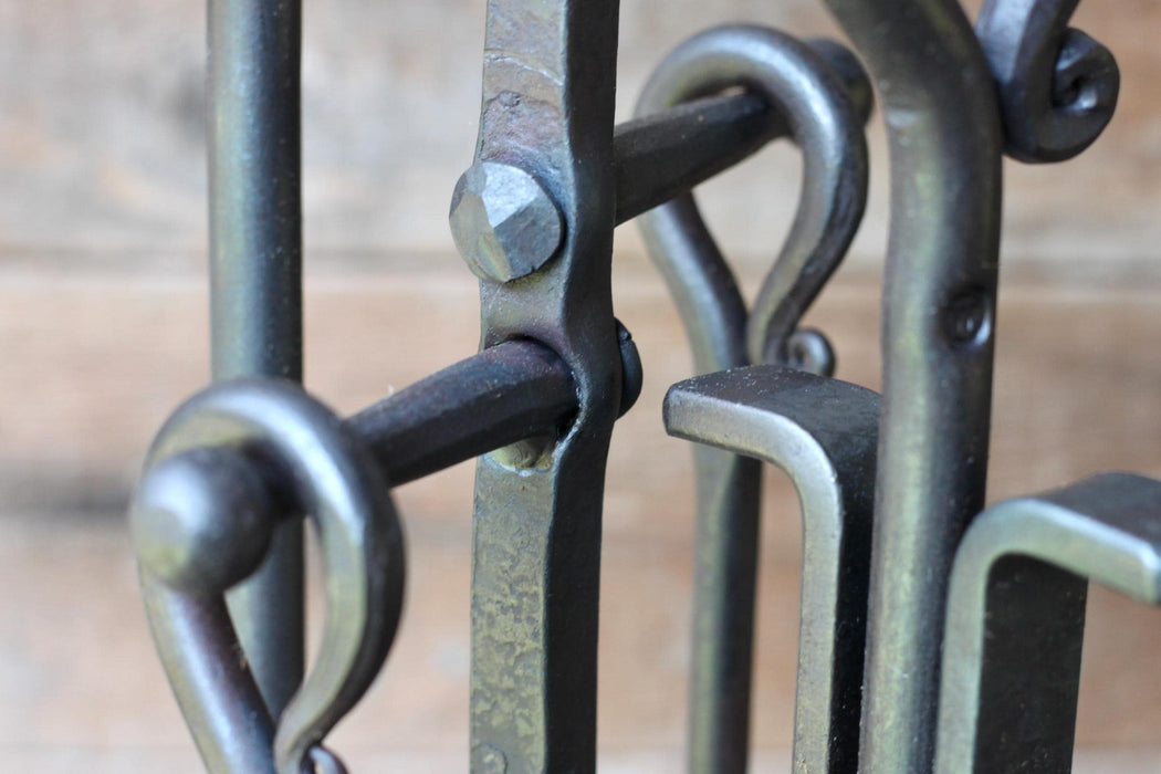 close up handles on a fire toolset showing rivets and handles 