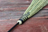 fireplace broom against a wood background 