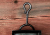 loop and scroll handle of a shovel against a wooden background 
