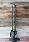 fireplace tools on a stand against a wooden background by wicks forge 