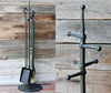 fire toolsannd stand with a wooden wall background 