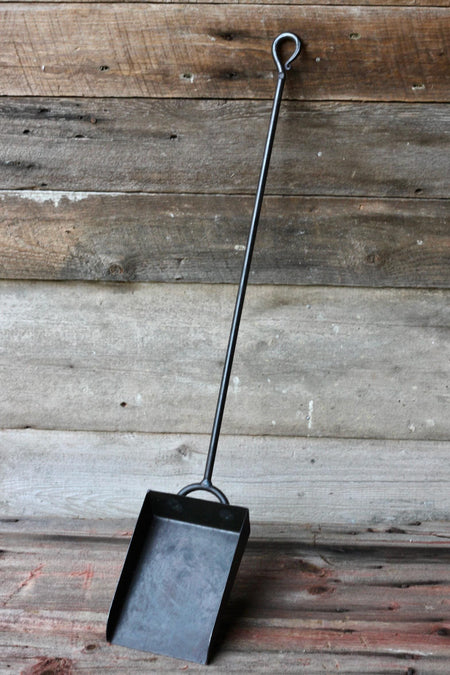 black shovel against a wooden wall by wicks forge 