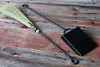 broom and shovel against a rustic wood surface by wicks forge 