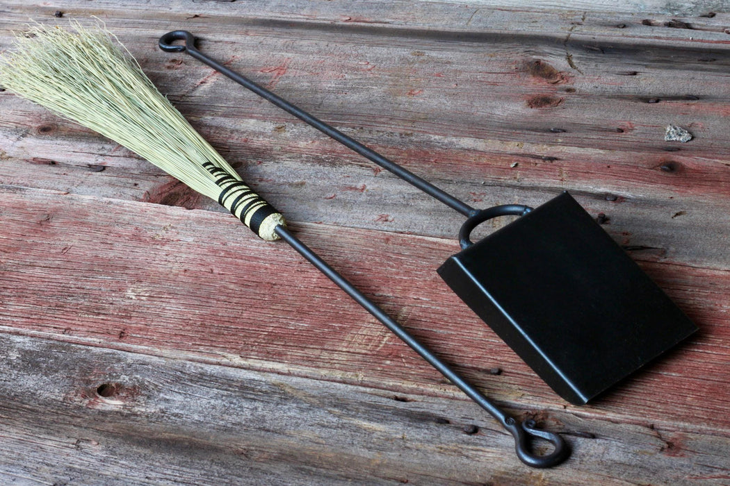 broom and shovel against a rustic wood surface by wicks forge 