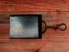 a black shovel on a wooden table 