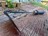 balc garden weeder on a wooden surface with a plant by wicks forge 