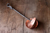 a blacksmith hand forged copper spoon rest under a ladle by Wicks Forge