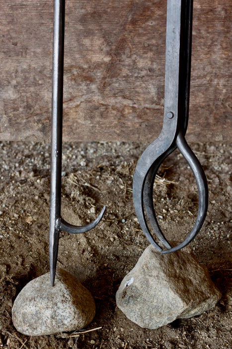  a blacksmith hand forged log grabber and 34 inch fire poker by Wicks Forge