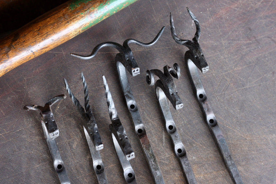 a collection of animal head hooks by Wicks Forge, including a Bull, Gazelle, Unicorn, Longhorn, Ram, and Antelope