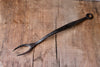 A blacksmith hand forged BBQ Fork with a circle handle by Wicks Forge