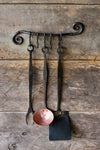 A blacksmith hand forged BBQ Fork, Ladle, and Spatula, hanging on a Curly Pot and Pan Rack by Wicks Forge