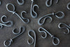 several blacksmith hand forged bottle openers by Wicks Forge