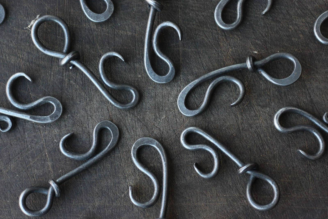 several blacksmith hand forged bottle openers by Wicks Forge