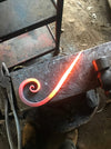 a bookend scroll in the process of being hand forged by Wicks Forge