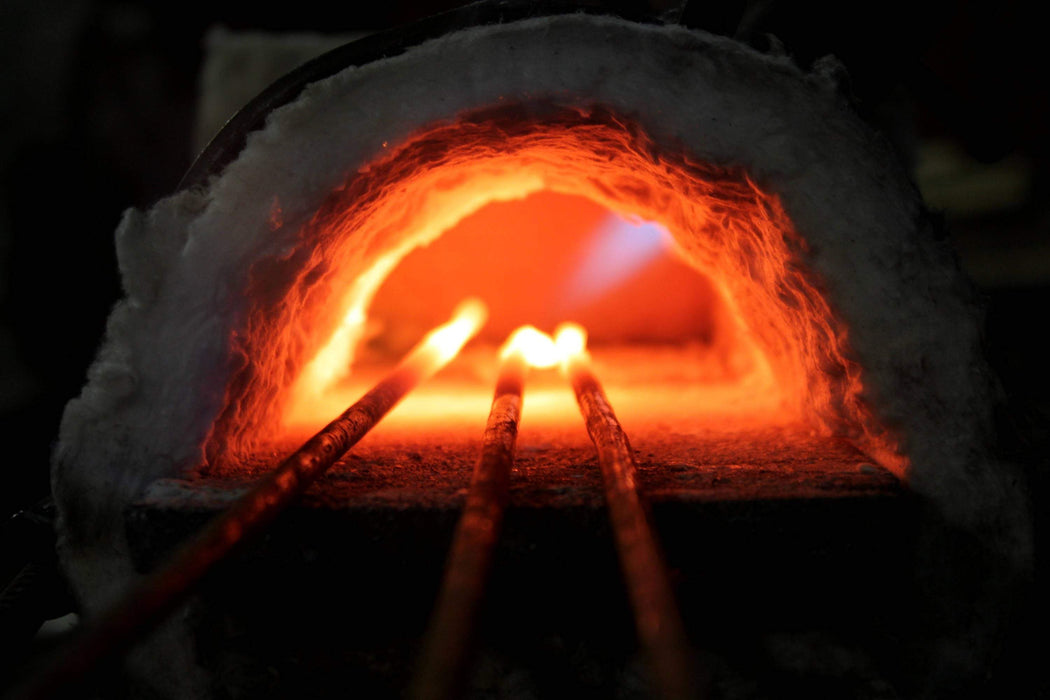 a blacksmith forge heating metal