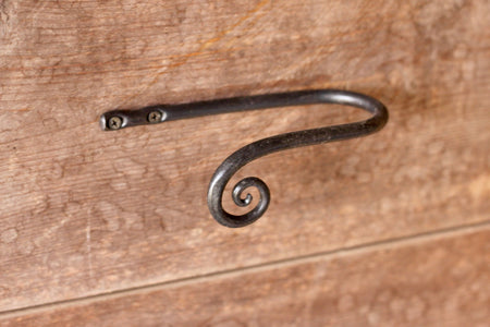 a blacksmith hand forged curtain holdback with a curl design by Wicks Forge