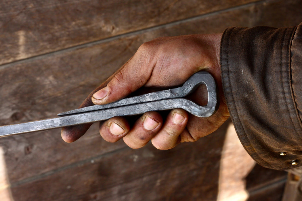 a hand forged deco style fire poker by Wicks Forge