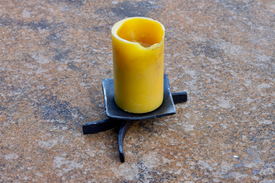 a blacksmith hand forged decorative candle stand by Wicks Forge