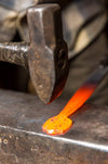 a blacksmith forging an egg spoon handle out of heated steel by Wicks Forge