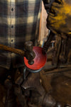 a blacksmith forging an egg spoon dish out of heated steel by Wicks Forge
