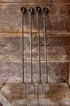 4 campfire rasters standing against a rustic wooden background 