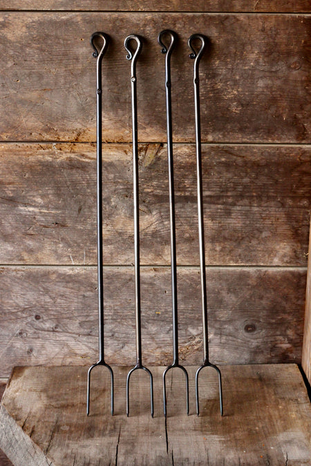 4 campfire rasters standing against a rustic wooden background 
