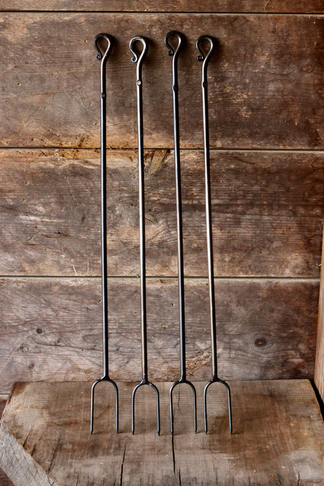 4 campfire rasters standing against a rustic wooden background 