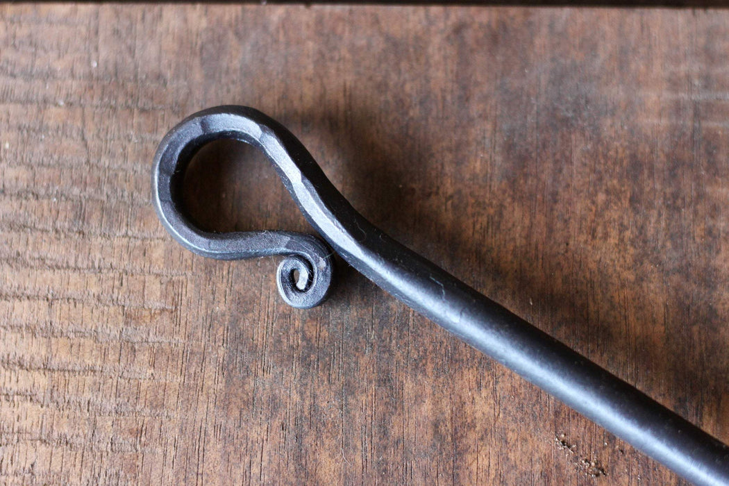 a blacksmith hand forged egg spoon with a curled handle by Wicks Forge