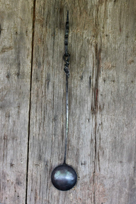 a blacksmith hand forged egg spoon with a leaf handle by Wicks Forge