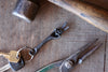 hand keychain and keys with pliers showing on a wooden table 