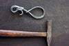 a blacksmith hand forged bottle opener with a leaf design by Wicks Forge