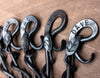 a blacksmith hand forged personalized bottle opener with a leaf design by Wicks Forge
