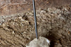 a blacksmith hand forged fire poker with a leaf wrap design by Wicks Forge