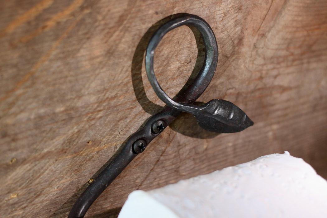 a blacksmith hand forged toilet paper holder with a leaf detail by Wicks Forge